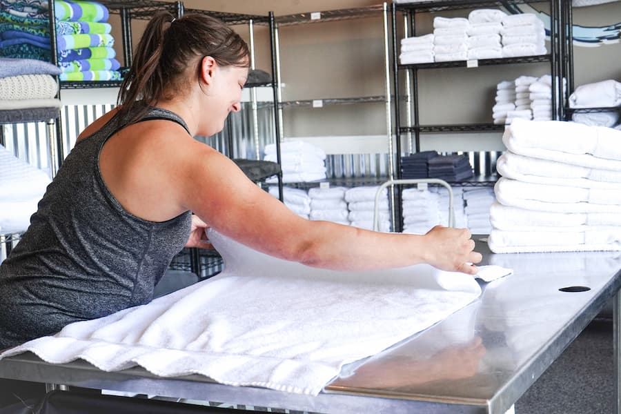 Linens being folded in the DoCo laundry